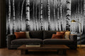 black and white forest wallpaper in a living room